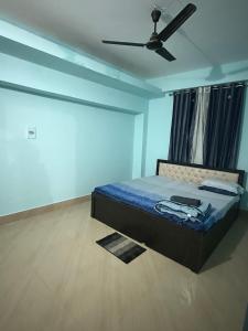 a bedroom with a bed and a ceiling fan at Gray Haven Homestay in Guwahati