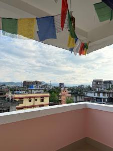 a view of a city from a balcony with clotheslines at Gray Haven Homestay in Guwahati