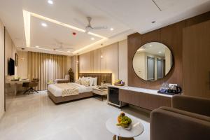 a hotel room with a bed and a large mirror at The Delhi Dreams - A Luxury Hotel in New Delhi