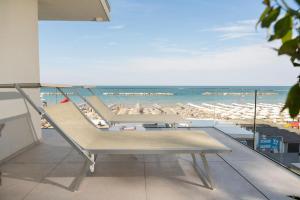 a view of a beach with chairs and umbrellas at Hotel delle Nazioni in Pesaro