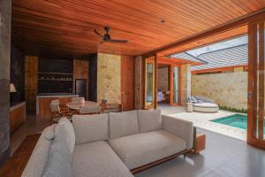 a living room with a couch and a table at Villa Sucasas, Luxury Pool Villa Nusa Dua, Bali in Nusa Dua