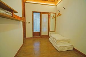 a room with two mattresses on the floor and a door at Jeonju Hanok Agbae in Jeonju +67 photos