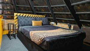 a bed in a room with a brick wall at Bavarian Maun Apartments in Maun