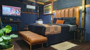 a bedroom with a bed and a bench at Bavarian Maun Apartments in Maun