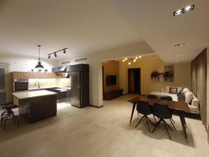 a large kitchen and living room with a table and chairs at Cordoba Suites in Hurghada