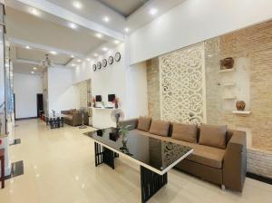 a living room with a couch and a table at Cosiana Hue Hotel in Hue