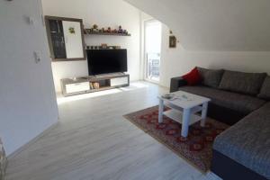 a living room with a couch and a table at NEU! FeWo Maria Buch in Neresheim
