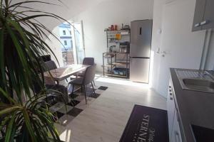 a kitchen with a table and a refrigerator at NEU! FeWo Maria Buch in Neresheim