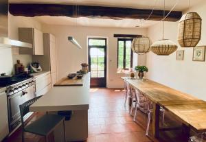 a kitchen with a large island with a wooden counter top at La Hurre in Montiron