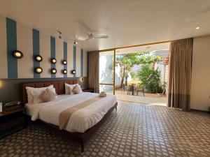 a bedroom with a large bed with blue and white stripes at Touchwood Bliss Nature Retreat - Igatpuri in Igatpuri +222 photos