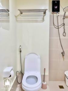 a white bathroom with a toilet and a sink at Solace - 1BR Brenthill Condo with Balcony Near Session and SM in Baguio +21 photos