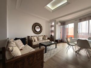 a living room with a couch and a table at Beldi Chic vue Mer - Taghazout in Agadir nʼ Aït Sa