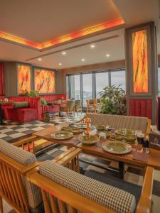 a dining room with a table and chairs at Blue Moon Hotel in Erbil
