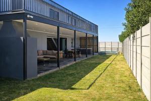 an external view of a house with a yard at Van Temp Beach House in Britannia Bay
