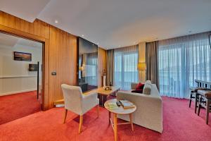 a living room with a couch and a table at Kalamper Hotel & Spa in Dobra Voda