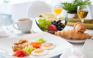 a plate of food with eggs and bread on a table at Hotel Park in Čakovec