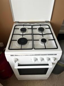 a white stove top oven sitting in a kitchen at Gite Camélia in La Réorthe
