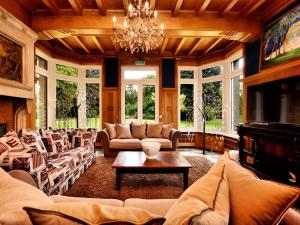 a large living room with couches and a chandelier at Luxury Estate with Pool & Spa in Jamoigne