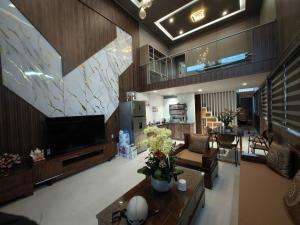 a large living room with a large television and a living room at Ánh Dương House 2 in Da Thanh