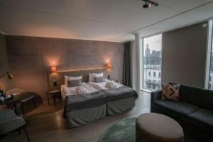 a hotel room with a bed and a couch at Scandic Continental in Stockholm +107 photos