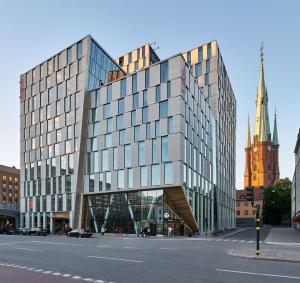 a large glass building on a city street at Scandic Continental in Stockholm