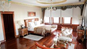 a bedroom with a bed and a chair in it at Meyra Palace in Ankara +63 photos