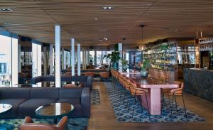 a lobby with couches and tables in a library at Scandic Continental in Stockholm