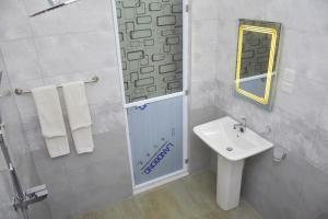 a white bathroom with a sink and a mirror at Ceylon Relax Villa in Aluthgama +24 photos