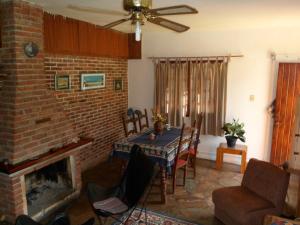 a living room with a table and a fireplace at Alquileres en Piriápolis Coriman & Luz de Luna in Piriápolis