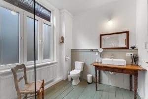a bathroom with a sink and a toilet at BELETAGE in Emden +17 photos
