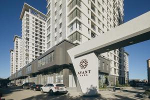 a large apartment building with a sign in front of it at Avant Park GK Aparts in Baku