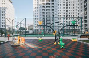 a playground in a city with buildings in the background at Avant Park GK Aparts in Baku