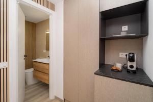 a bathroom with a sink and a counter top at Boutique Centro Hostal in Alicante