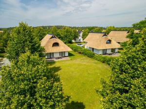 an overhead view of a house with a grass yard at Van der Valk Resort Linstow in Linstow