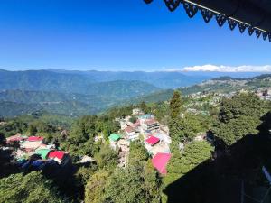 an aerial view of a village in the mountains at Tholangi Homes in Darjeeling