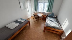 a room with two beds and a table in it at 4easy Unterkünfte in Unterflockenbach +38 photos