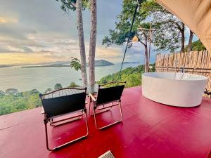 two chairs and a bath tub sitting on a porch at Sireha Cafe Resort and Glamping in Ban Khok Chang +33 photos