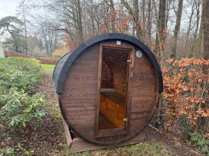 a large wooden out house in the woods at Exclusive Duplex Mansion with Sauna & Pool in Charlottenlund