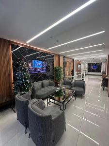 a living room with a christmas tree and couches at İstanbul Trend Hotel Old City in Istanbul +118 photos