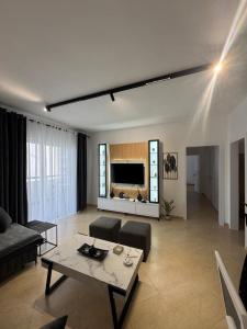 a living room with a couch and a table at Cloud 4 Apartment in Lezhë