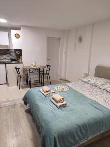 a bedroom with a bed with two towels on it at Apartments Viking - In The OLD TOWN of SPLIT in Split