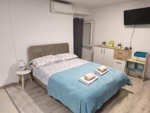 a bedroom with a bed with two towels on it at Apartments Viking - In The OLD TOWN of SPLIT in Split +58 photos