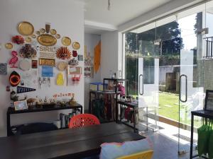 a dining room with a table and a window at Siril Guesthouse Hostel in Nuwara Eliya