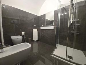 a bathroom with a shower and a sink and a toilet at Dimora Di Davide in LʼAquila