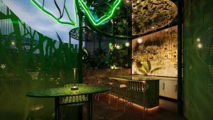 a bar with a green table and chairs at KiN Hotel Central Park in Ho Chi Minh City +23 photos