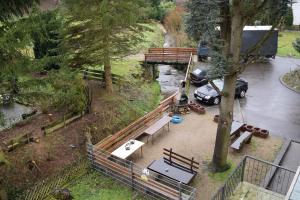 a park with a bench and a parking lot with a car at 4easy Unterkünfte in Unterflockenbach