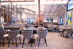 a restaurant with tables and chairs in a room at Altes Kurhaus Landhotel in Trabelsdorf