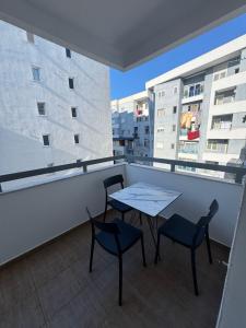 a balcony with a table and chairs on a building at Cloud 4 Apartment in Lezhë