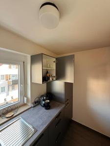 a kitchen with a counter top and a window at Freudenstadt City Apartment in Freudenstadt