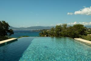 a swimming pool with a view of the water at VILLA IMPERIALE vue mer piscine in Pietrosella
